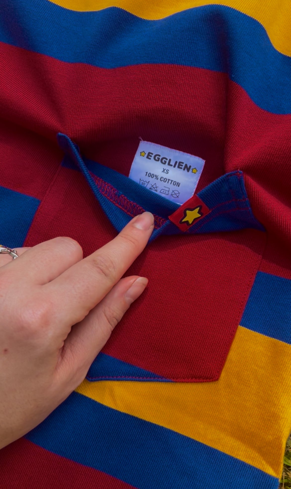 Colorful striped fabric with a brand label sewn in the pocket of the shirt