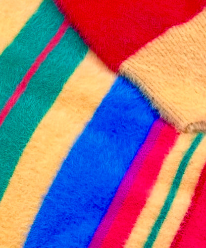 Close-up of colorful fuzzy striped fabric with red, blue, green, yellow, purple and pink.