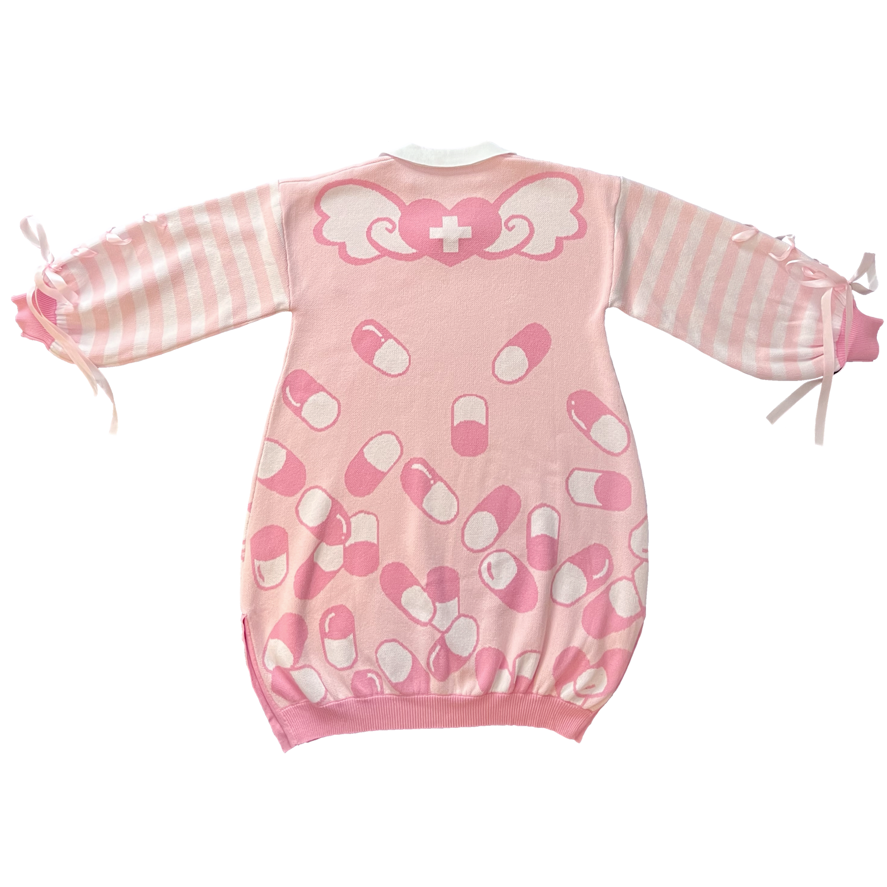 Flat lay image of the back of the pink menhera sweater dress. The sweater dress body is pastel pink with darker pink and white capsules on it. On the top part of the body there is a pink heart with a white cross that has wings coming out of the heart. The sleeves are pastel pink and white striped with pastel pink ribbons installed to form a bow on the end of the sleeves. 