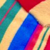 Close-up of colorful fuzzy striped fabric with red, blue, green, yellow, purple and pink.