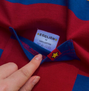 Colorful striped fabric with a brand label sewn in the pocket of the shirt