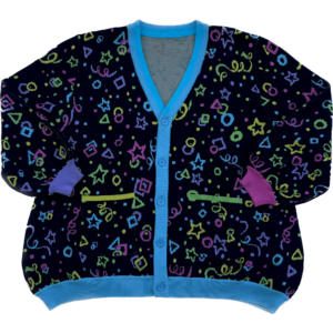 A multicolored cardigan laying flat with the front facing the camera. The cardigan is bright pink,. purple, yellow, green and blue stars, circles, triangles, squares and confetti on a black background.