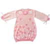 Flat lay image of the back of the pink menhera sweater dress. The sweater dress body is pastel pink with darker pink and white capsules on the bottom with a heart with wings on the top with a white collar. The sleeves are pastel pink and white striped with pastel pink ribbons installed to form a bow on the end of the sleeves.