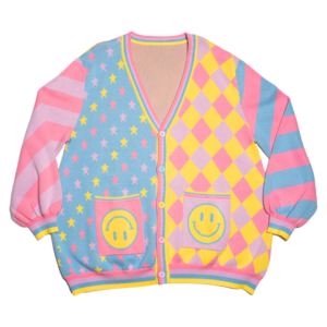 Pastel multicolored cardigan with smiley face pockets on a white background. Cardigan sleeves are alternating color stripes with the front panels being multicolored stars, and a diamond checkered pattern with happy face pockets.