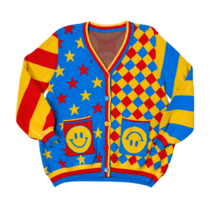 Bright red, yellow and blue cardigan laying flat with the front of the cardigan facing the camera. Cardigan has alternating color star patterns, checkered diamond patterns, alternating stripe sleeves and happy face pockets.