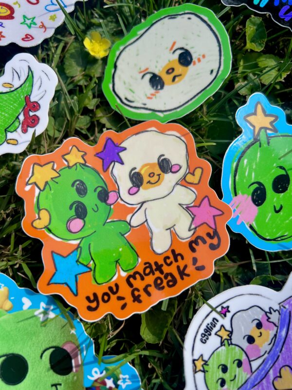 Colorful stickers with cartoon characters on a grass background