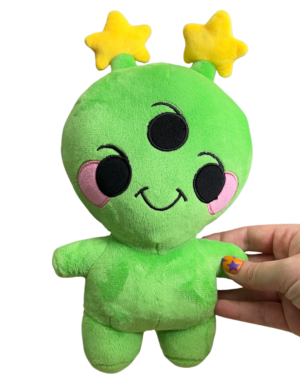 hand holding medium sized cheerful alien plush. Alien has three eyes, pink round cheeks, two yellow star antennae