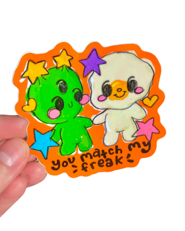 Colorful stickers with an alien cartoon character and egg characters held by a hand on a clear background