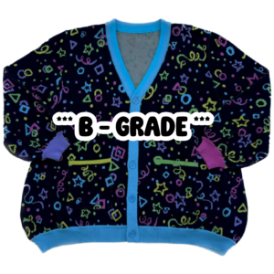 A multicolored cardigan laying flat with the front facing the camera with the text "***B-GRADE*** displayed in the center. The cardigan is bright pink,. purple, yellow, green and blue stars, circles, triangles, squares and confetti on a black background.
