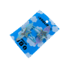 Holo Blue Hair Clip side A pair of holographic stars with wings on blue hairclips both on a blue backing card that reads "Egglien".