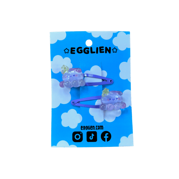 A pair of purple octopus cabochons on purple hairclips both on backing card that reads "Egglien"