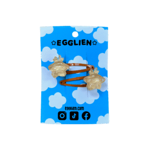 A pair of orange cabochons on orange hairclips both on blue backing card that reads "Egglien"