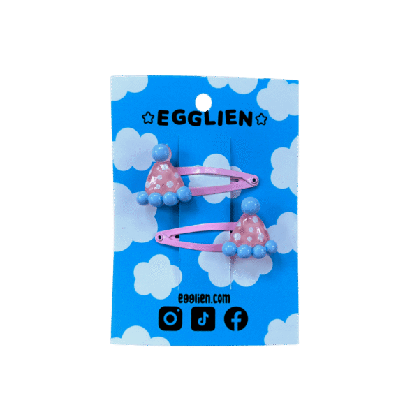 party hat hair clip front A pair of pink and blue party hat cabochons on pink hairclips both on blue backing card that reads "Egglien"