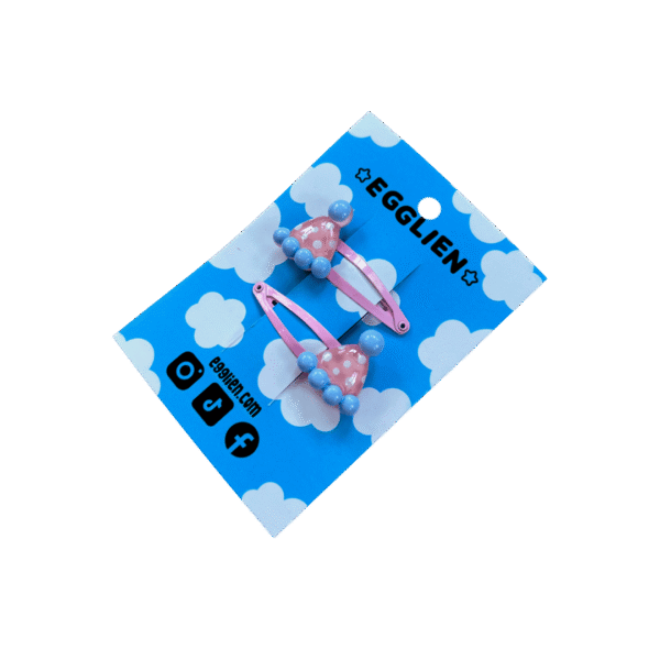 party hat hair clip side A pair of pink and blue party hat cabochons on pink hairclips both on blue backing card that reads "Egglien"