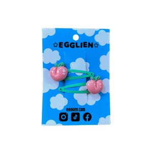 peach hair clip front A pair of peach cabochons on mint hairclips both on blue backing card that reads "Egglien"
