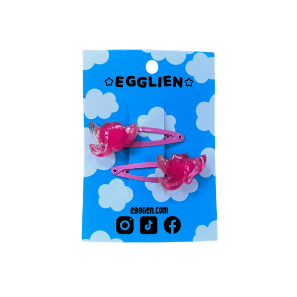 pink ray hair clip front A pair of pink ray cabochons on pink hairclips both on blue backing card that reads "Egglien"