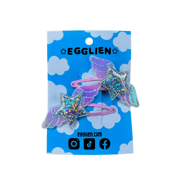 Pink Holographic Hair clip front A pair of holographic stars with wings on pink hairclips both on a blue backing card that reads "Egglien".