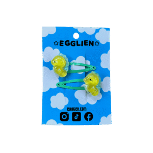 seahorse hair clip front A pair of yellow sea horse cabochons on orange hairclips both on mint backing card that reads "Egglien"