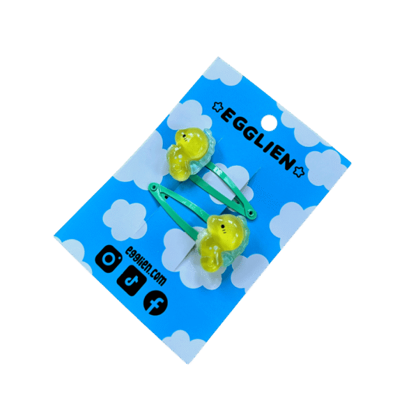 seahorse hair clip side A pair of yellow sea horse cabochons on orange hairclips both on mint backing card that reads "Egglien"