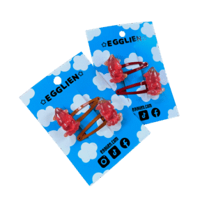A pair of red squid resin cabochon hairclips both on backing card that reads "Egglien". One pair has orange hair clips and the other has red.