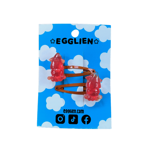 squid orange hair clip front A pair of red squid cabochons on orange hairclips both on a blue backing card that reads "Egglien"