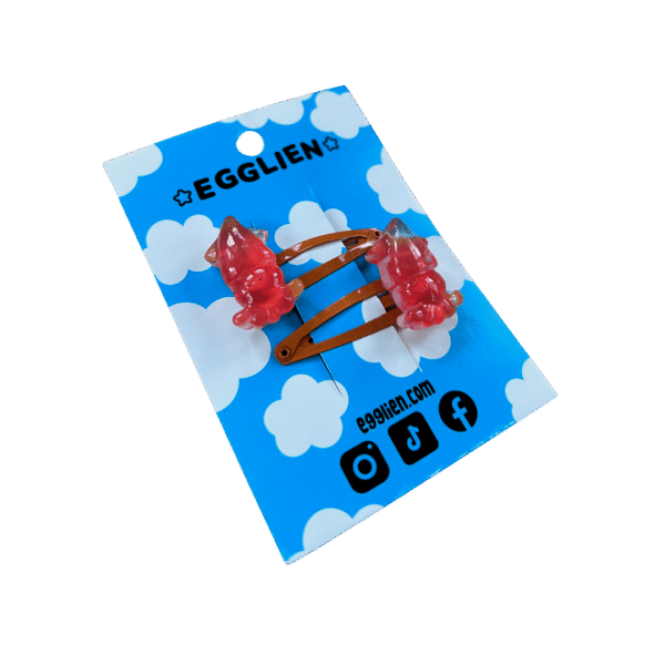 squid orange hair clipside A pair of red squid cabochons on orange hairclips both on a blue backing card that reads "Egglien"