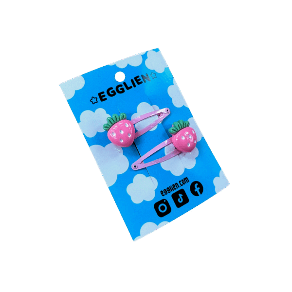 A pair of pink strawberry cabochons on pink hairclips both on a blue backing card that reads "Egglien"
