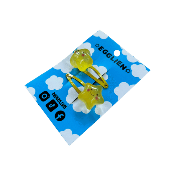 A pair of yellow cheerful star cabochon on yellow hairclips both on backing card that reads "Egglien"