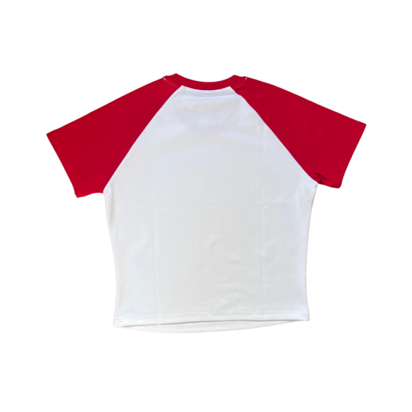 A white crop top laying flat on a clear background. The shirt has a white body with red short sleeves.